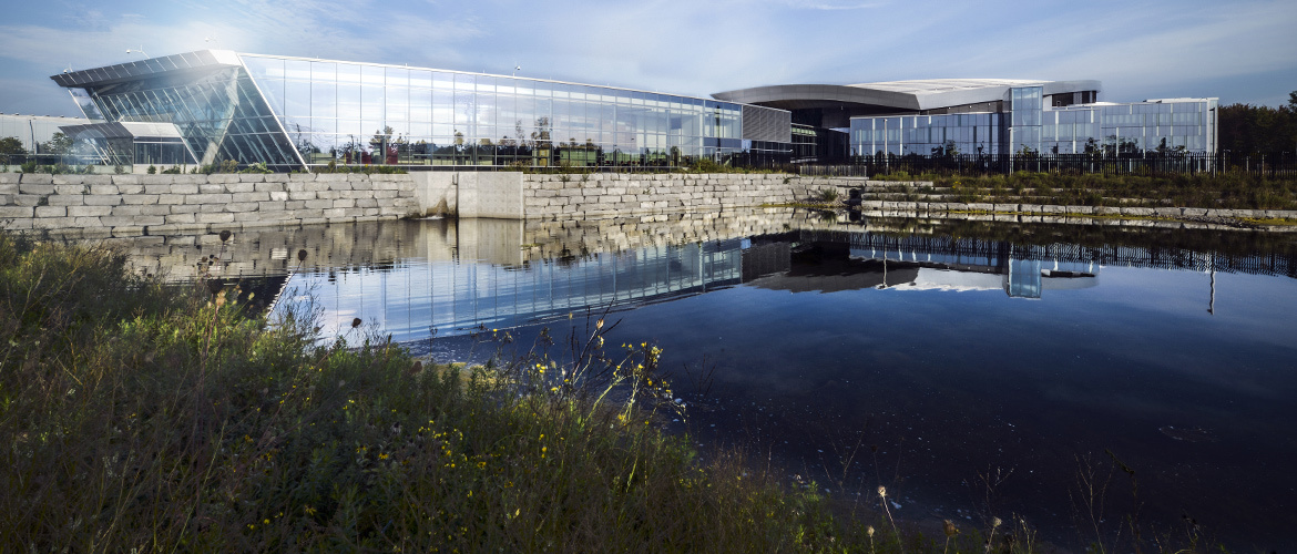 Outside view of CSE Edward Drake Building from across a pond