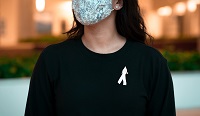 A white ribbon on a person’s black shirt